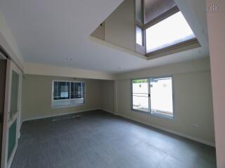 Spacious living room with large windows and ample natural light