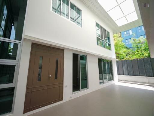 Exterior of a modern building with large windows and a brown door