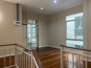 Open landing area with wooden flooring and bright lighting