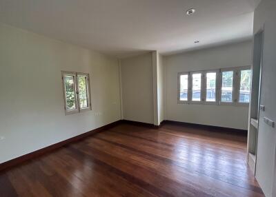 Spacious living room with wooden flooring and natural light