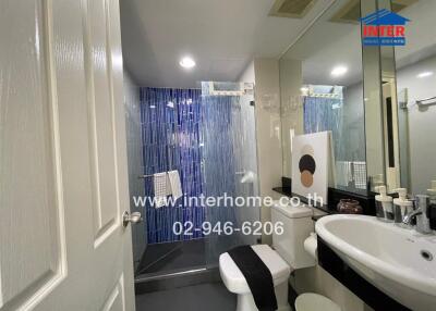 Modern bathroom with shower curtain and well-lit vanity area