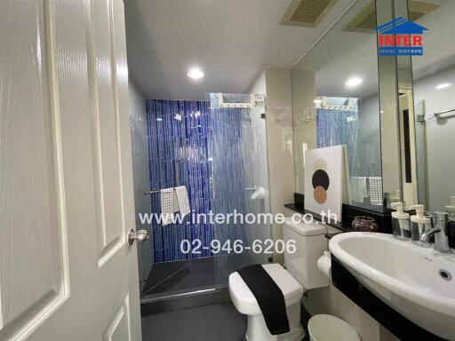 Modern bathroom with shower curtain and well-lit vanity area