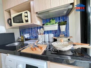 Modern kitchen with elegant blue tile backsplash and sleek appliances