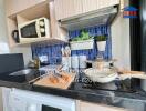 Modern kitchen with elegant blue tile backsplash and sleek appliances