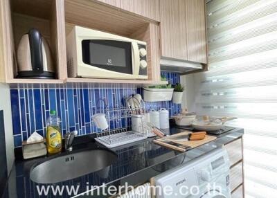 Modern compact kitchen with appliances and wooden cabinets