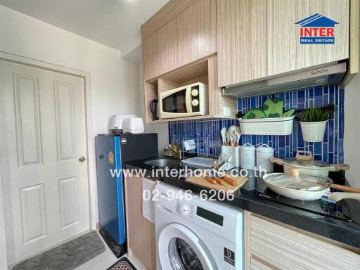 Compact modern kitchen with blue tile backsplash and integrated appliances