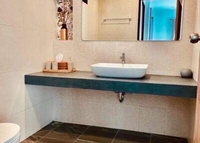Modern bathroom with stylish fixtures and earthy tones