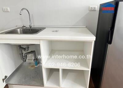 Small kitchen area with sink and under-cabinet space