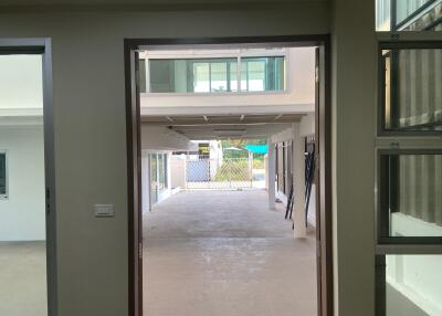View of a modern residential building courtyard from an open doorway