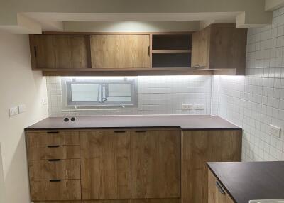 Modern kitchen with wooden cabinets and tiled backsplash