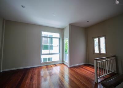 Spacious living room with hardwood floors and large windows