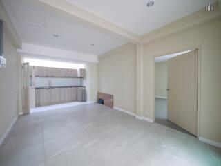 Spacious open plan living area with adjacent kitchen