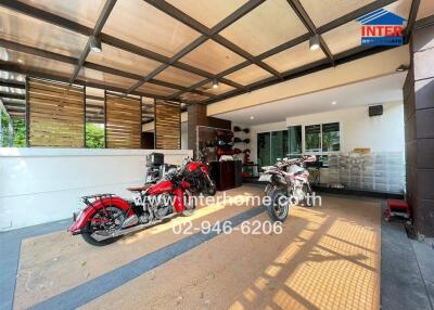 Spacious covered garage with multiple motorcycles and storage space