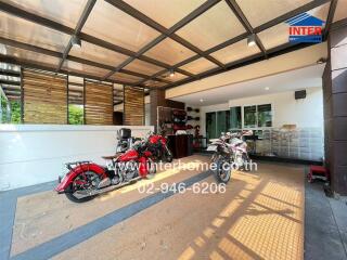 Spacious covered garage with multiple motorcycles and storage space