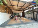 Modern carport attached to a residential home with transparent roof and a collection of motorcycles