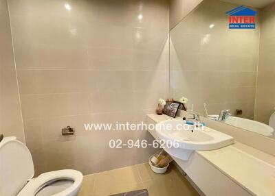 Spacious and modern bathroom with dual sinks and large mirror