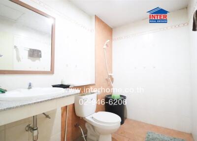Clean and well-maintained bathroom with white fixtures and mirror