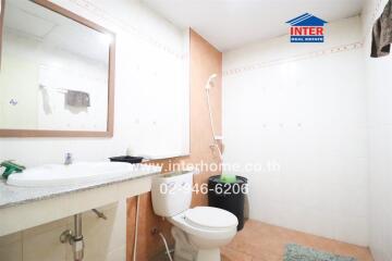 Clean and well-maintained bathroom with white fixtures and mirror