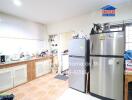 Spacious kitchen with multiple appliances and wooden cabinetry