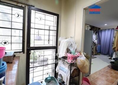 Spacious indoor laundry area with large windows and storage space