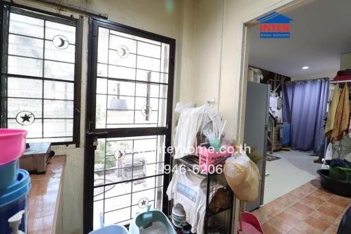 Spacious indoor laundry area with large windows and storage space