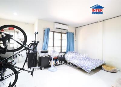 Bright and spacious bedroom with bicycle and air conditioner