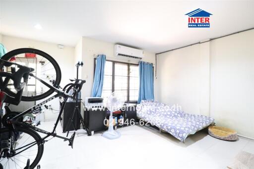 Bright and spacious bedroom with bicycle and air conditioner