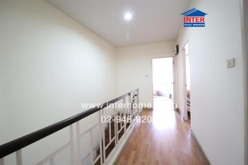 Spacious and well-lit hallway leading to a room, ideal for property ad cover