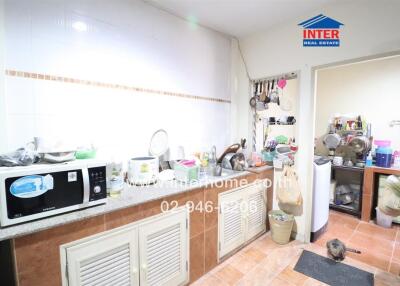 Spacious kitchen interior with appliances and storage cabinets
