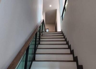 Modern staircase with glass railing in a residential building