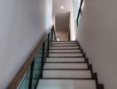 Modern staircase with glass railing in a residential building