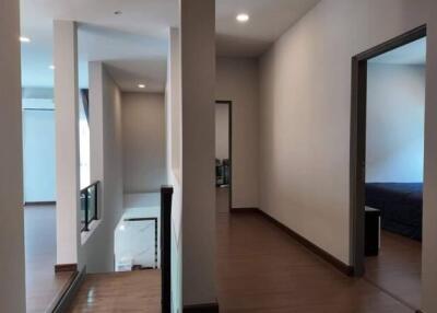 Modern hallway leading to a bedroom with natural light