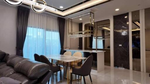 Elegant living room and dining area with modern furnishings and decor