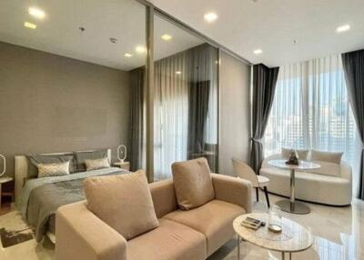 Modern bedroom combined with living space featuring elegant furniture and ample lighting