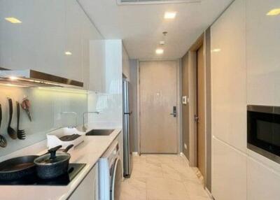 Modern kitchen interior with built-in appliances and glass backsplash