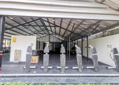 Spacious covered outdoor gym with various fitness equipment