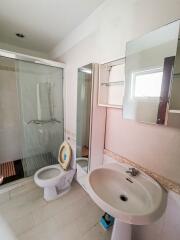 Spacious bathroom with glass shower and modern fixtures