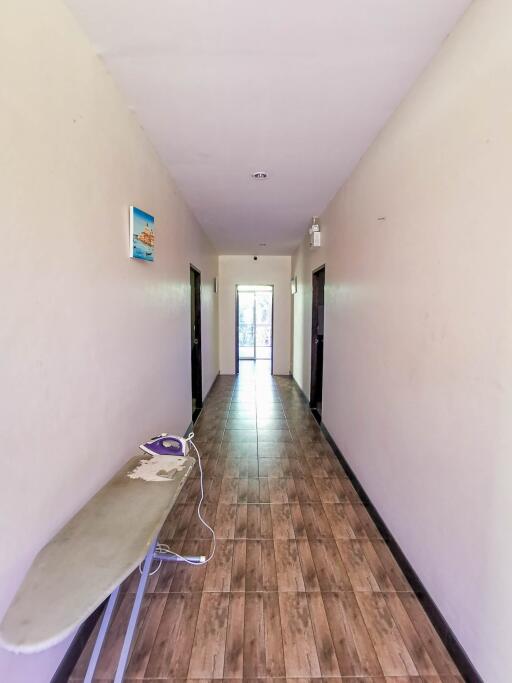 Spacious hallway with wooden flooring and natural light