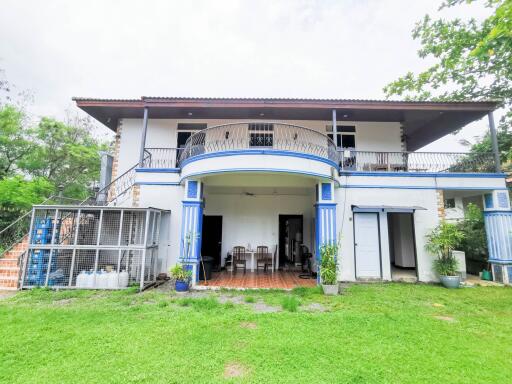 two-story house with balcony and spacious outdoor area