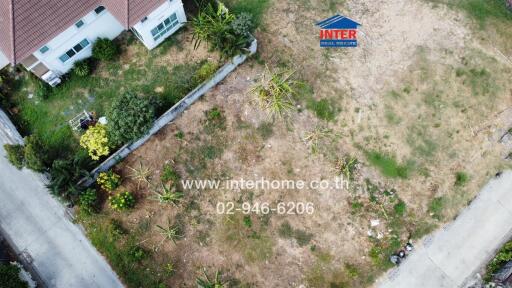 Aerial view of residential property with surrounding landscaping and real estate signage