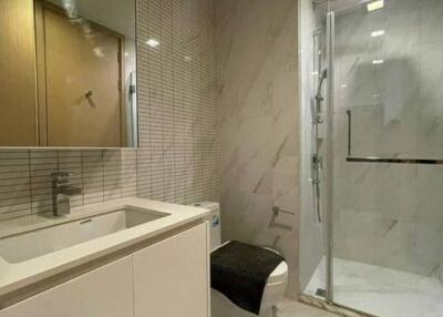 Modern bathroom with a glass shower and white vanity