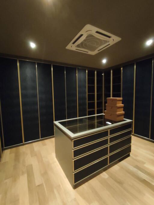 Modern bedroom with custom cabinetry and wooden flooring