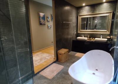 Modern spacious bathroom with freestanding tub and glass shower