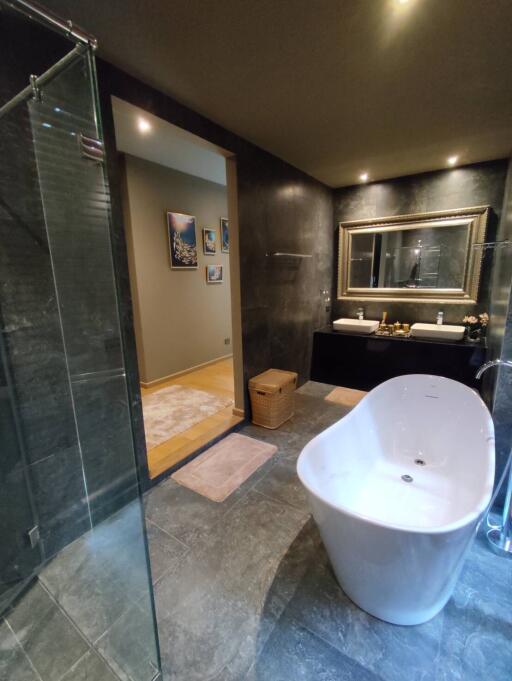 Modern spacious bathroom with freestanding tub and glass shower