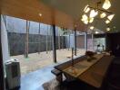 Spacious living room with unique lighting fixtures and large window view to the courtyard