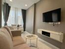 Modern living room with taupe sofa and wall-mounted TV