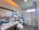 Modern bathroom interior with well-lit vanity area and glass shower enclosure