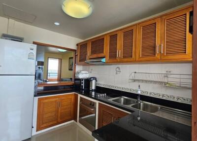 Spacious kitchen with modern appliances and wooden cabinets