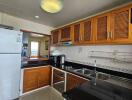 Spacious kitchen with modern appliances and wooden cabinets