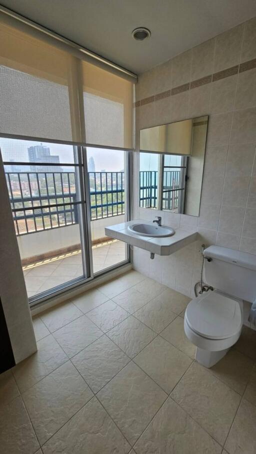 Modern bathroom with floor-to-ceiling windows and city view